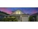 House exterior at night with a beautiful sunset in the background at 1452 Brookebridge Dr, Orlando, FL 32825