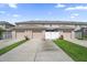 Three-car garage exterior view with driveway and basketball hoop at 1625 Reflection Cv, Saint Cloud, FL 34771