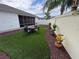 Artificial turf backyard with fire pit and seating at 1631 Edisto Ln, The Villages, FL 32162