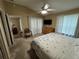 Main bedroom with king-size bed and access to the living room at 1631 Edisto Ln, The Villages, FL 32162