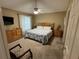 Bright bedroom with king-size bed and wood furniture at 1631 Edisto Ln, The Villages, FL 32162