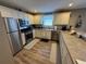 Updated kitchen with stainless steel appliances and wood flooring at 1631 Edisto Ln, The Villages, FL 32162