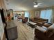 Comfortable living room with leather furniture and hardwood floors at 1631 Edisto Ln, The Villages, FL 32162