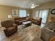 Spacious living room with hardwood floors and comfortable leather furniture at 1631 Edisto Ln, The Villages, FL 32162
