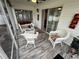 Bright sunroom with wicker furniture and tiled floor at 1631 Edisto Ln, The Villages, FL 32162