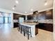 Modern kitchen with dark cabinetry, granite counters, and a large island at 31771 Broadwater Ave, Leesburg, FL 34748