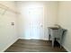 Bright laundry room featuring a sink, shelving, and wood-look flooring at 1310 Tallahassee Ct, Poinciana, FL 34759