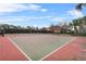 Outdoor basketball court with well-maintained surfaces, basketball hoop, and perimeter fencing at 7642 Fairgrove Ave, Windermere, FL 34786