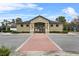 Community clubhouse with brick path, manicured landscaping, and covered entrance at 7642 Fairgrove Ave, Windermere, FL 34786