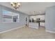 Open kitchen and dining area with stainless steel appliances, white cabinetry, and tile flooring at 7642 Fairgrove Ave, Windermere, FL 34786