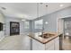 Bright kitchen boasts granite counters, pendant lighting and stainless steel dishwasher at 7642 Fairgrove Ave, Windermere, FL 34786