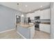 Modern kitchen with granite counters, stainless appliances, pendant lights, and tile floors at 7642 Fairgrove Ave, Windermere, FL 34786
