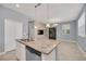 Open kitchen with granite countertops, pendant lights, and stainless steel dishwasher at 7642 Fairgrove Ave, Windermere, FL 34786