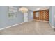 Bright and airy living space with tile flooring, large windows, and modern chandelier lighting at 7642 Fairgrove Ave, Windermere, FL 34786