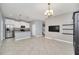 Open layout with stainless steel appliances, island seating, and modern lighting fixtures at 7642 Fairgrove Ave, Windermere, FL 34786