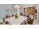 Beautiful dining and living area featuring a modern chandelier, tile flooring, and comfortable seating arrangements at 7642 Fairgrove Ave, Windermere, FL 34786
