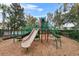 Community playground with slides, climbing structure, and fenced perimeter at 7642 Fairgrove Ave, Windermere, FL 34786