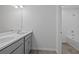 Bright bathroom featuring a double sink vanity with modern fixtures and a tub with white tiled walls at 1197 Happy Forest Loop, Deland, FL 32720