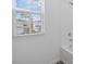 Natural light streams through the window, illuminating the white tiled shower in this bathroom at 1197 Happy Forest Loop, Deland, FL 32720