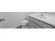 Powder bathroom featuring a gray vanity, white countertop, modern faucet, and a toilet at 1197 Happy Forest Loop, Deland, FL 32720