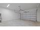 Spacious garage with white concrete flooring and garage door at 1197 Happy Forest Loop, Deland, FL 32720