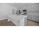 Modern kitchen features stainless steel appliances, gray cabinets and a large island with white countertops at 1197 Happy Forest Loop, Deland, FL 32720