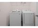 Convenient laundry room with modern Samsung washer and dryer set and wire shelving above at 1197 Happy Forest Loop, Deland, FL 32720