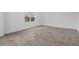 Spacious, empty living room showing the tile floors, baseboards and one window with natural light at 1197 Happy Forest Loop, Deland, FL 32720