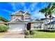Inviting two-story home showcasing a manicured lawn, lush landscaping, and an attached two-car garage at 122 Stone Gable Cir, Winter Springs, FL 32708