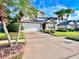Charming two-story home featuring a well-manicured lawn, mature landscaping, and an attached two-car garage at 122 Stone Gable Cir, Winter Springs, FL 32708