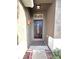 Elegant entryway features a decorative wood front door with glass accents and sconce lighting at 122 Stone Gable Cir, Winter Springs, FL 32708