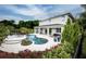 Home's backyard features a patio, pool, and lush landscaping at 2424 Park Ridge St, Apopka, FL 32712