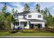 Two-story home featuring a meticulously landscaped front yard and charming architectural details at 2424 Park Ridge St, Apopka, FL 32712