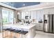 Modern kitchen boasts stainless steel appliances, gray cabinets, and an island with barstool seating at 2424 Park Ridge St, Apopka, FL 32712