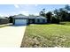 Attractive single-story home with manicured lawn, concrete driveway, and a two-car garage at 1209 Alafia Way, Poinciana, FL 34759