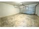 Empty garage with concrete flooring and a roll-up door at 1209 Alafia Way, Poinciana, FL 34759