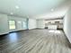Spacious living room with wood flooring, recessed lighting, and open layout with a modern kitchen at 1209 Alafia Way, Poinciana, FL 34759