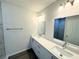 Modern bathroom features double vanity, stone countertops, and tiled shower at 1312 Hillsborough Ct, Poinciana, FL 34759