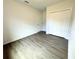 Cozy bedroom with wood-look floors, a closet, and a door at 1312 Hillsborough Ct, Poinciana, FL 34759