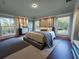 Stylish bedroom with large windows, wood floors, and neutral tones at 1312 Hillsborough Ct, Poinciana, FL 34759