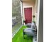 Cozy balcony with artificial grass, seating for two, and views of the community at 1990 Erving Cir # 201, Ocoee, FL 34761