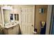 Bright bathroom features a white vanity with silver fixtures and a large mirror reflecting the bedroom at 1990 Erving Cir # 201, Ocoee, FL 34761