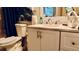 Comfortable bathroom vanity and toilet with soft lighting and a full mirror at 1990 Erving Cir # 201, Ocoee, FL 34761