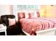 Well-lit bedroom featuring a cozy bed with decorative pillows, a comfortable chair, and bright natural light at 1990 Erving Cir # 201, Ocoee, FL 34761