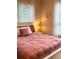 Inviting bedroom featuring a cozy bed with decorative pillows, natural light, and a charming bedside lamp at 1990 Erving Cir # 201, Ocoee, FL 34761