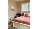 Comfortable bedroom featuring a plush bed with decorative pillows, a cozy chair, and a bright window at 1990 Erving Cir # 201, Ocoee, FL 34761
