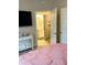 Bedroom with an open doorway to a bathroom featuring a white vanity, offering a glimpse into the en-suite at 1990 Erving Cir # 201, Ocoee, FL 34761