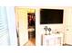 Spacious walk-in closet with organized shelving, visible from a bedroom featuring a modern TV and decor at 1990 Erving Cir # 201, Ocoee, FL 34761