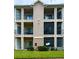 Exterior of a multi-story building with multiple balconies and well-maintained landscaping at 1990 Erving Cir # 201, Ocoee, FL 34761