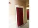 Exterior view of an apartment door with unit number 24 and a red door in the background at 1990 Erving Cir # 201, Ocoee, FL 34761